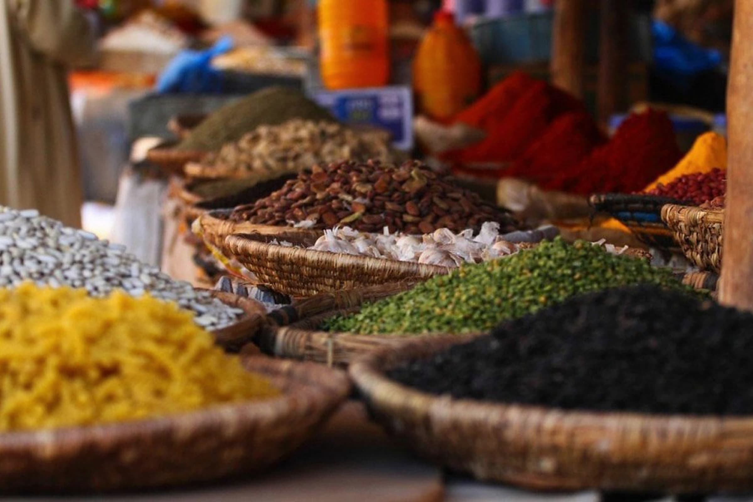 Baskets of spices and ingredients arranged at a Tanzanian market